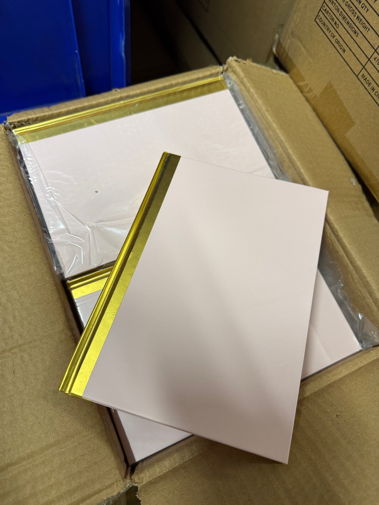Box of 40 A5 pink hardback notebooks with gold trim