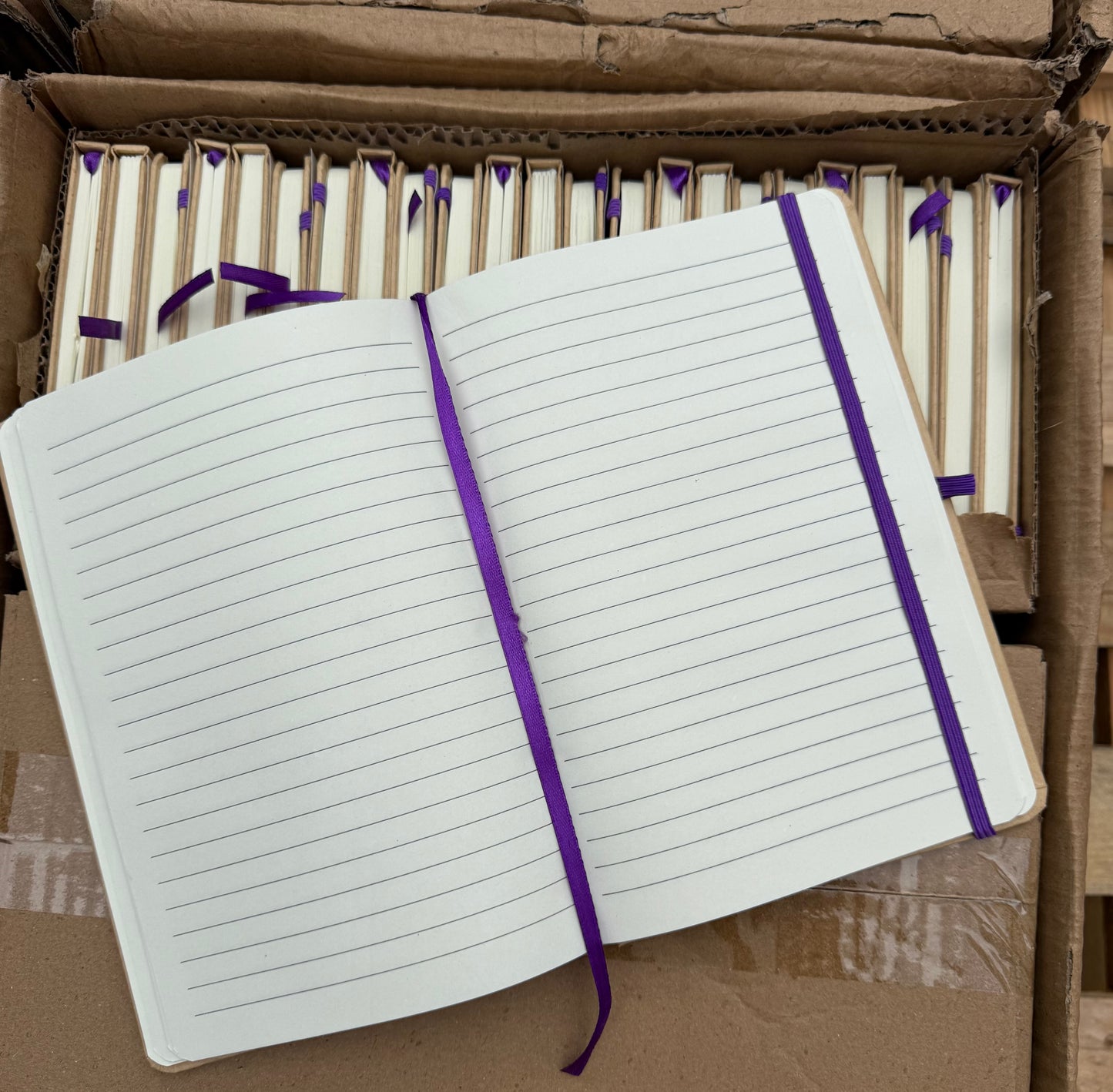 Box of 50 A5 hardback notebooks with coloured closure