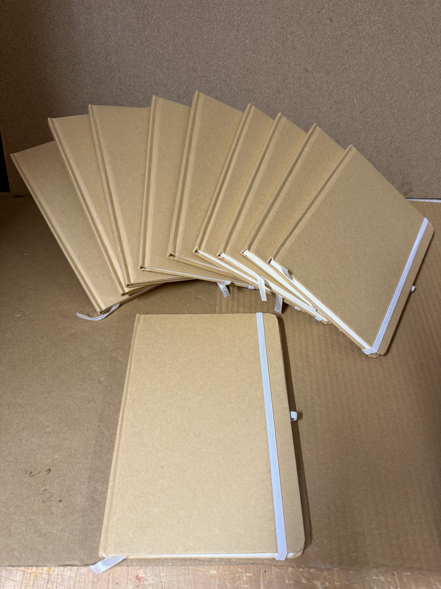 Bundle of A5 hardback notebooks with coloured closure