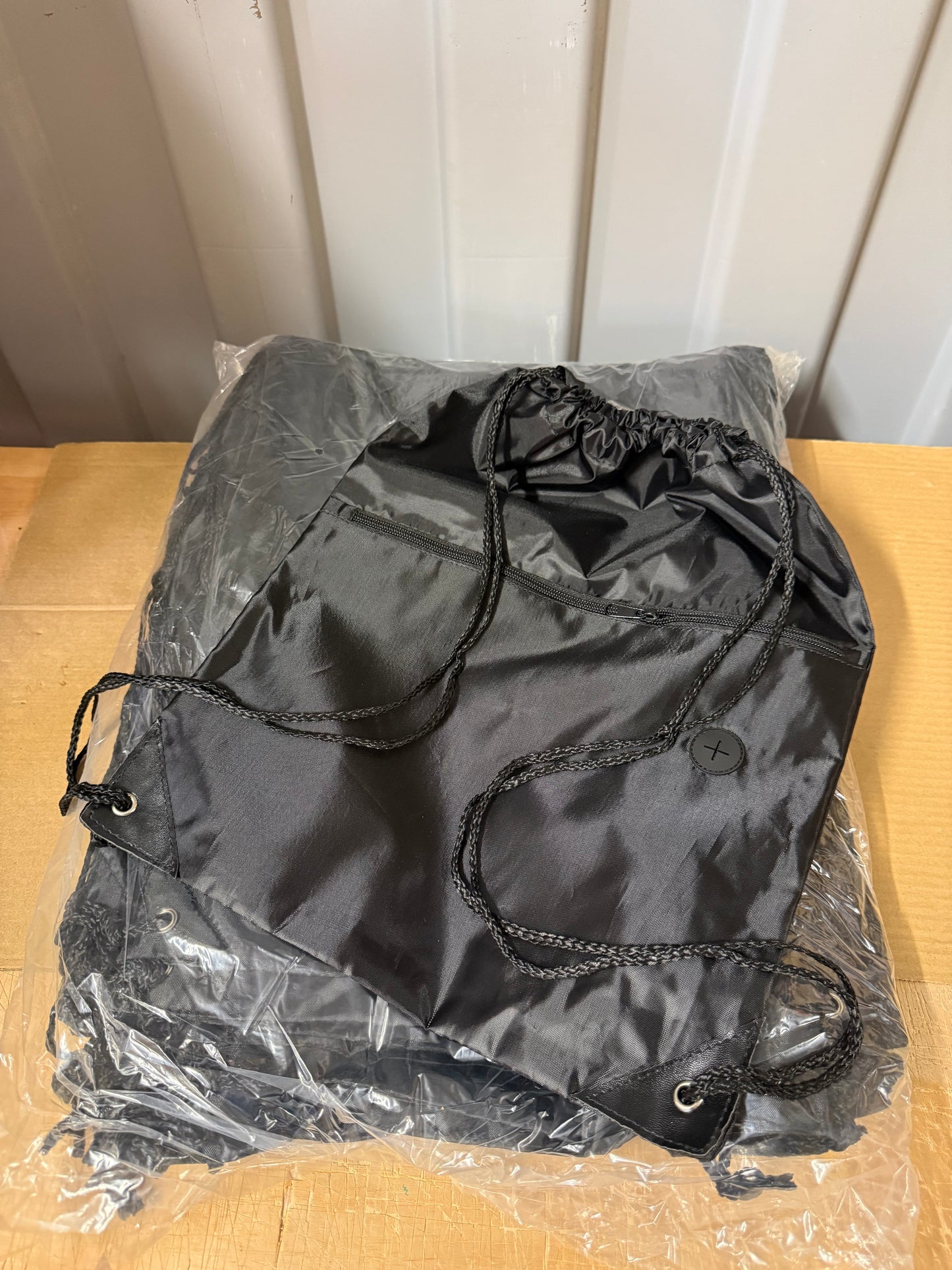 Pack of 50 Black drawstring sports bags with zip compartments