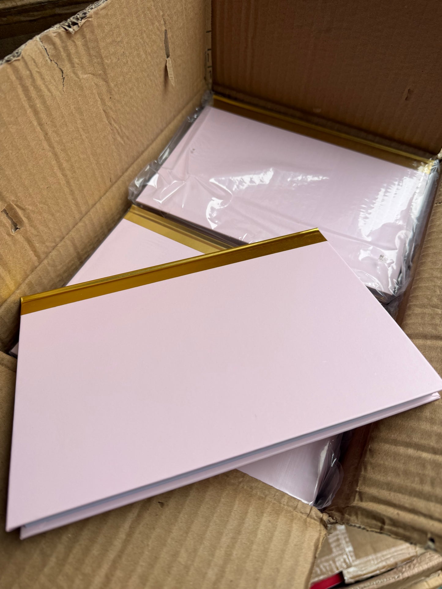 Box of 40 A5 pink hardback notebooks with gold trim