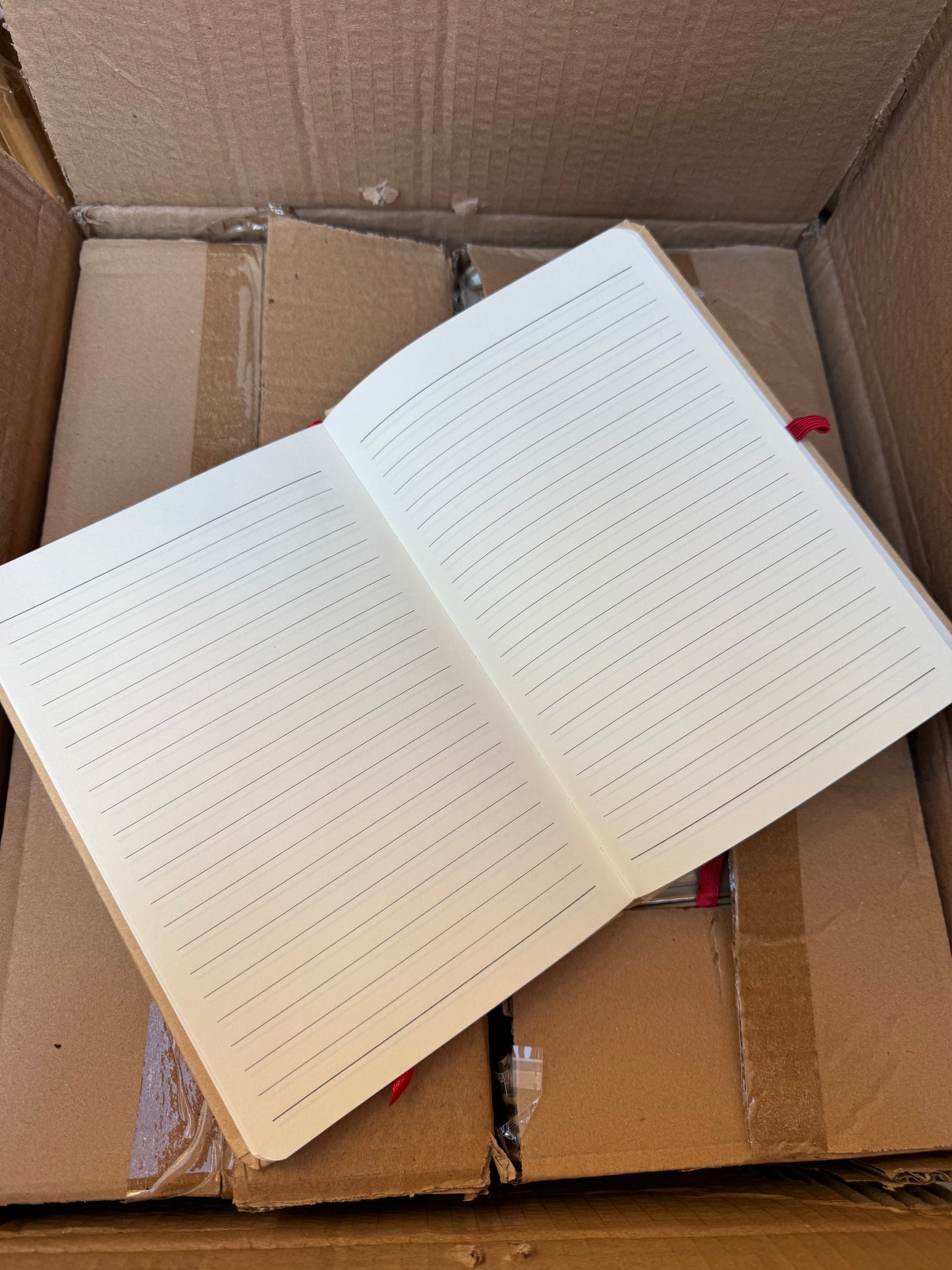 Box of 50 A5 hardback notebooks with coloured closure