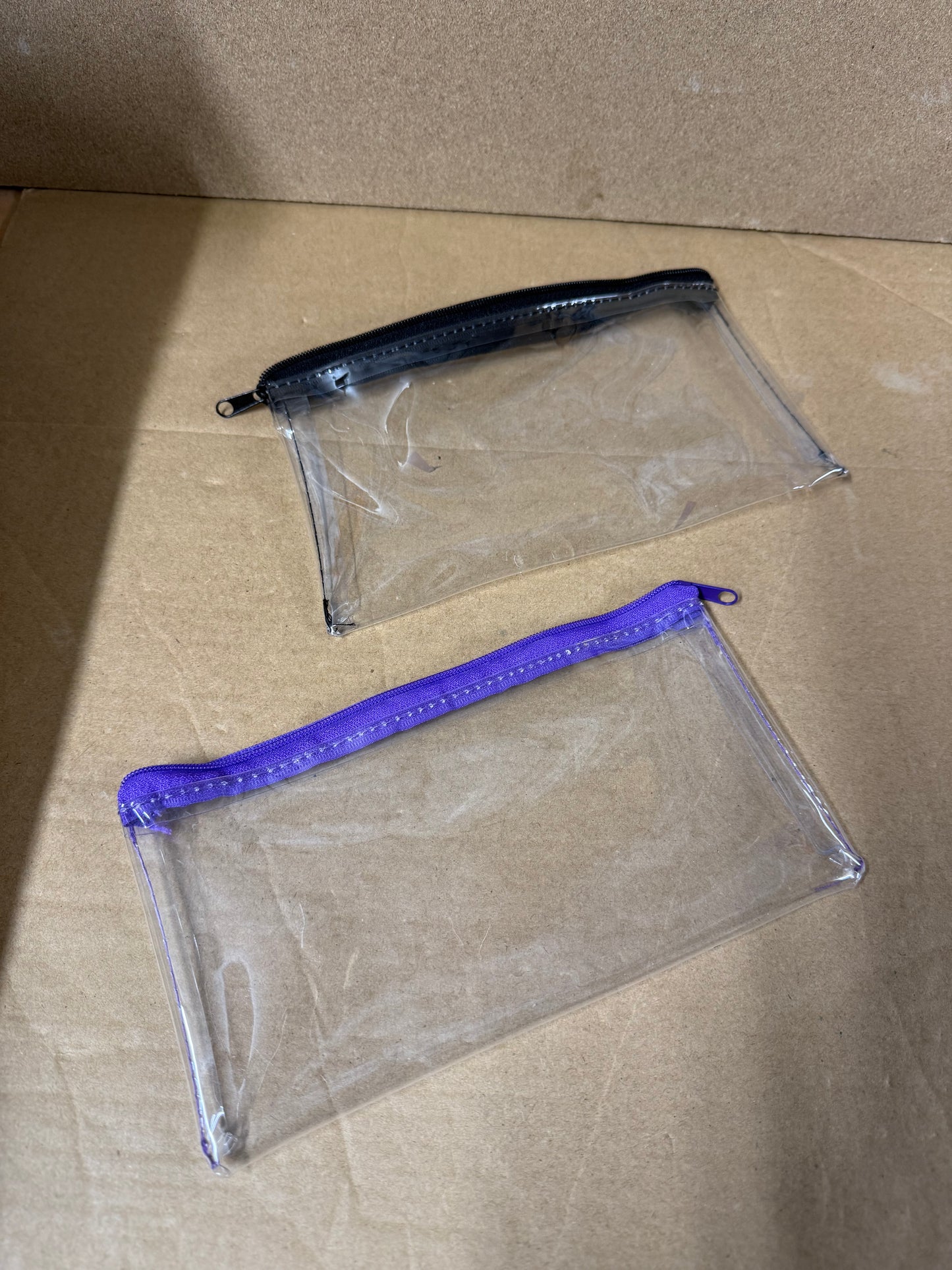 Box of 50 clear pencil cases featuring a colour zip
