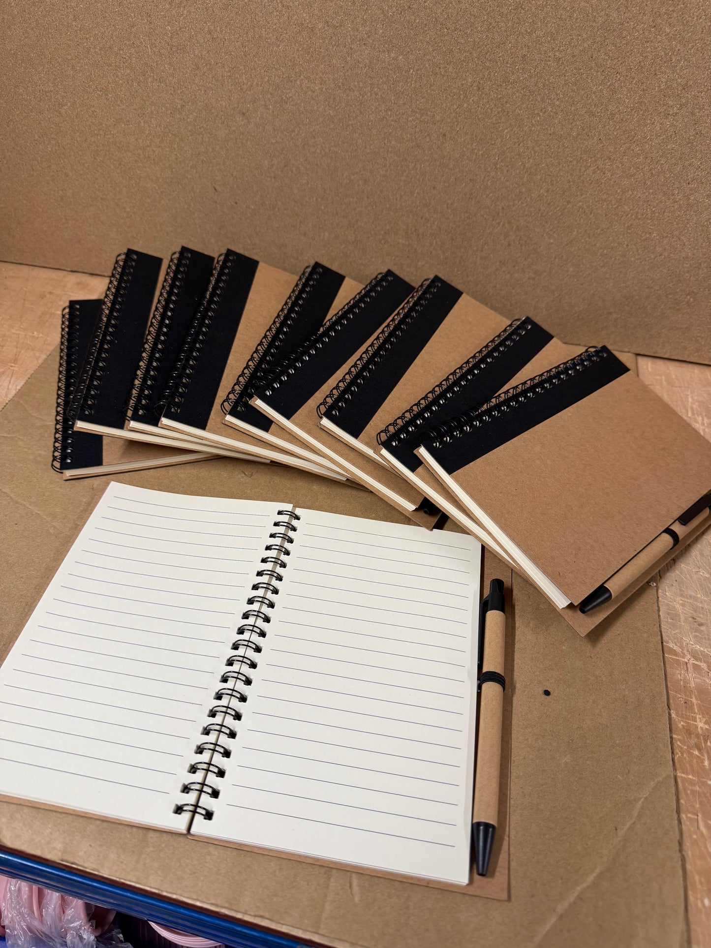 10x coloured spiral notebooks with pens