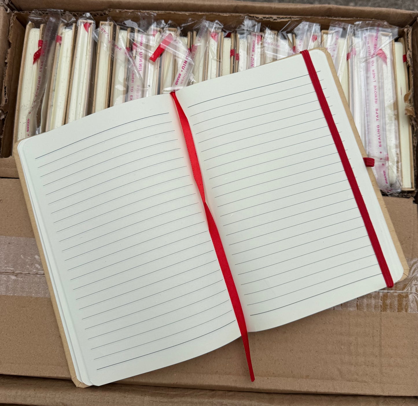 Box of 50 A5 hardback notebooks with coloured closure