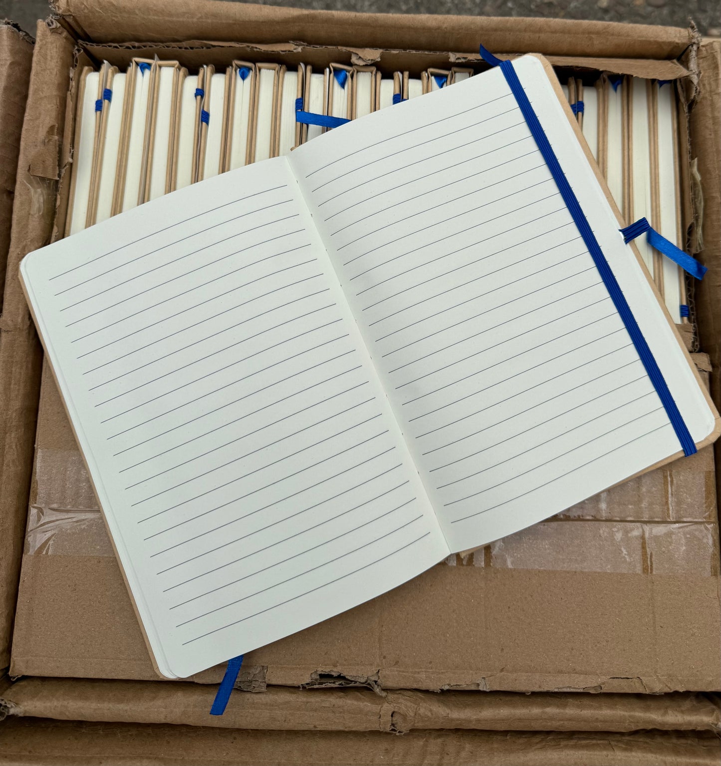 Box of 50 A5 hardback notebooks with coloured closure