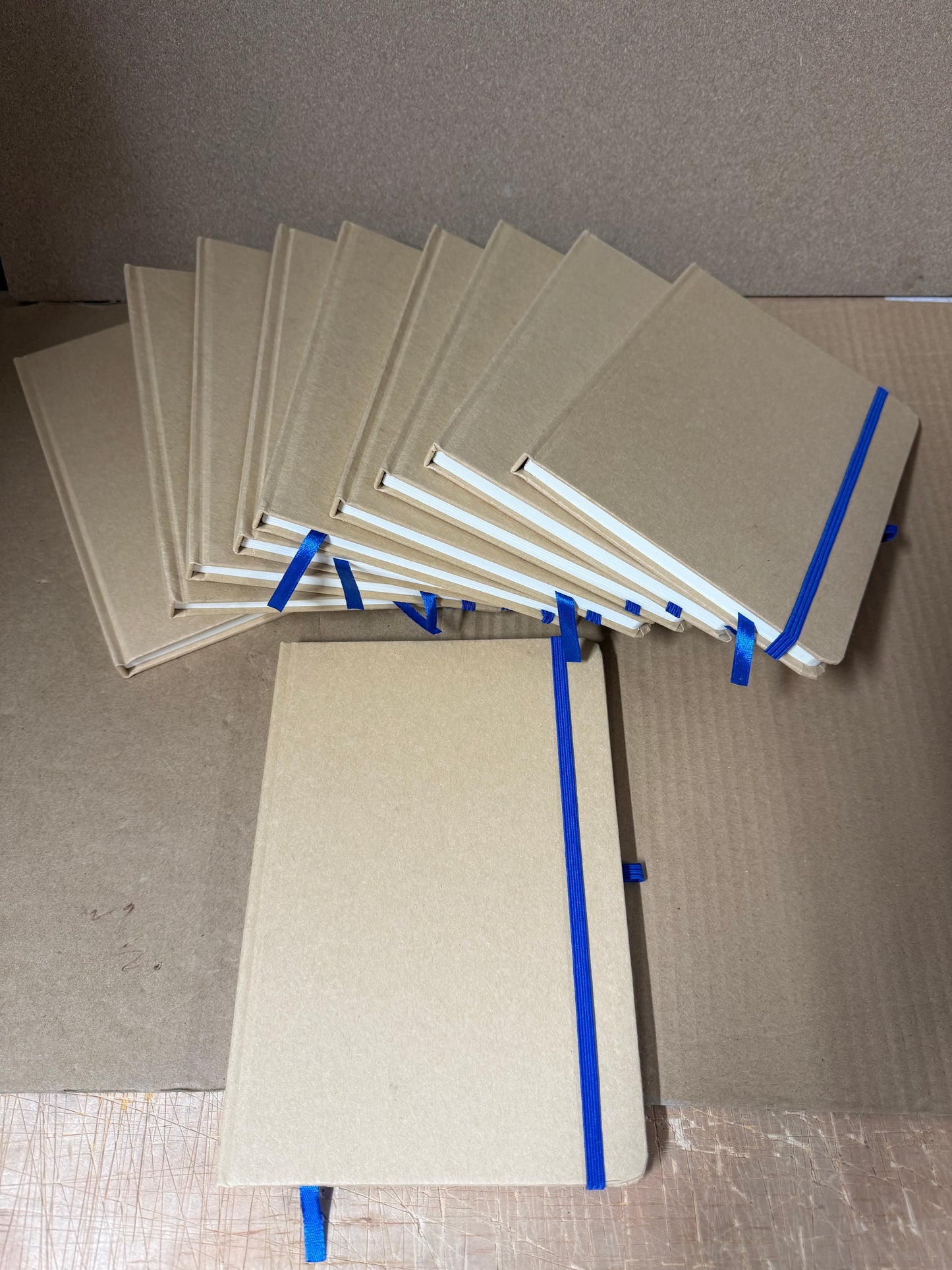 Bundle of A5 hardback notebooks with coloured closure