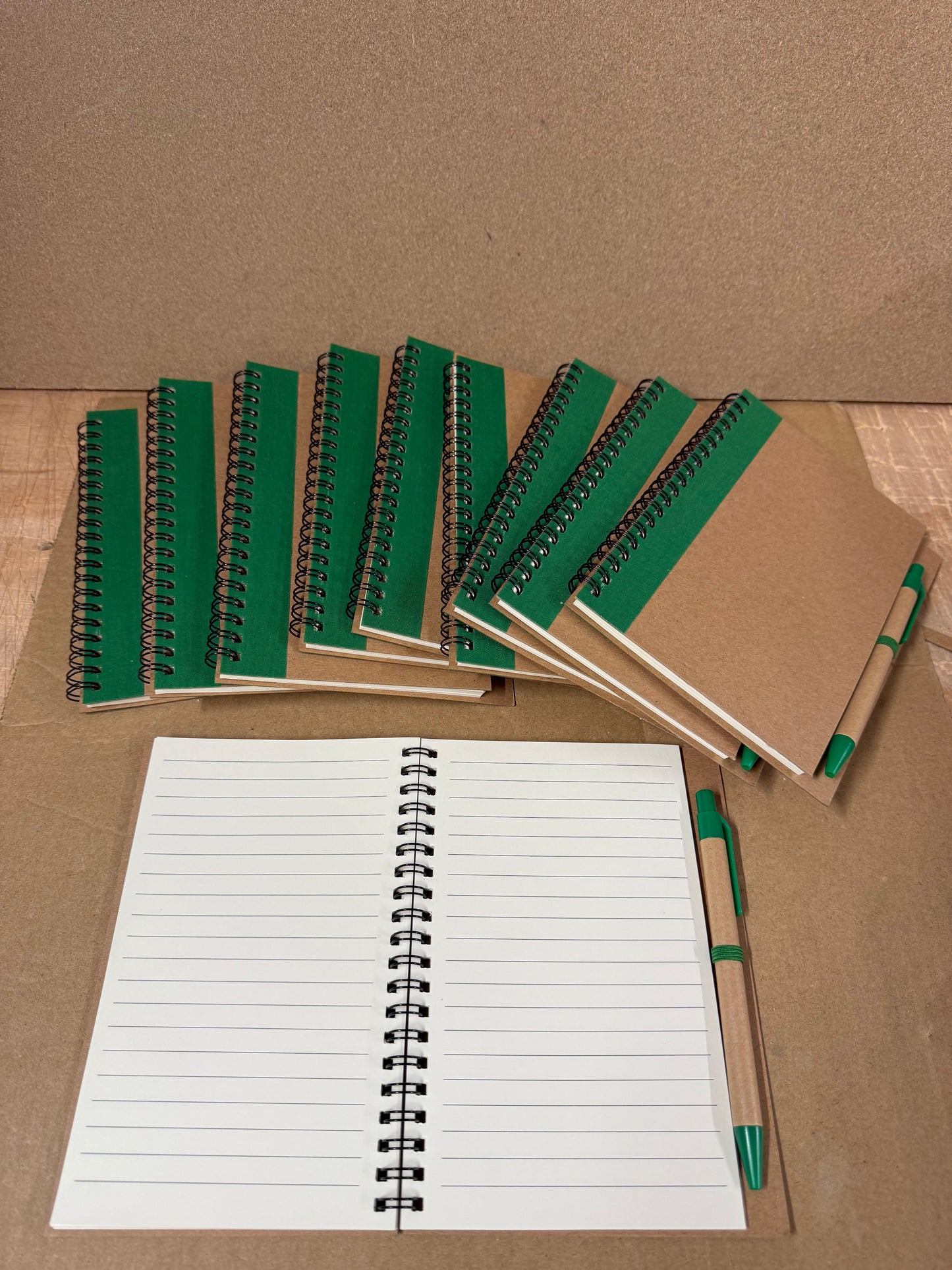10x coloured spiral notebooks with pens