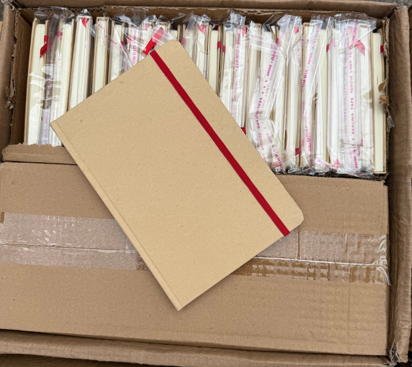 Box of 50 A5 hardback notebooks with coloured closure
