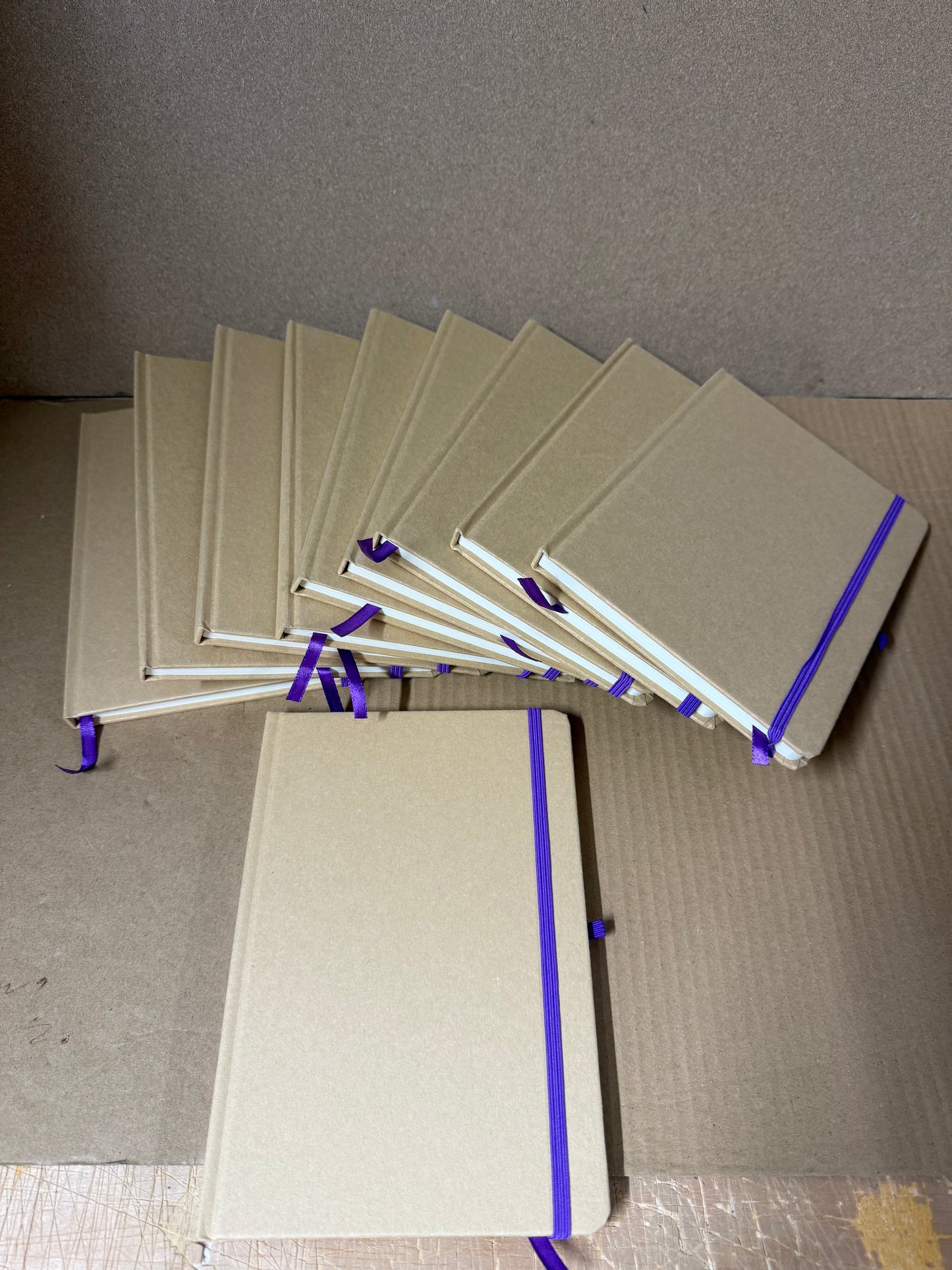 Bundle of A5 hardback notebooks with coloured closure