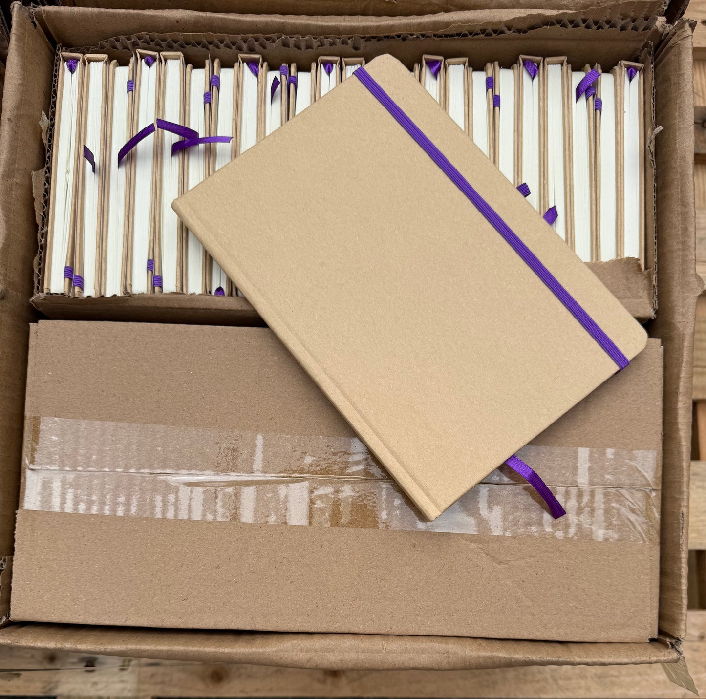 Box of 50 A5 hardback notebooks with coloured closure