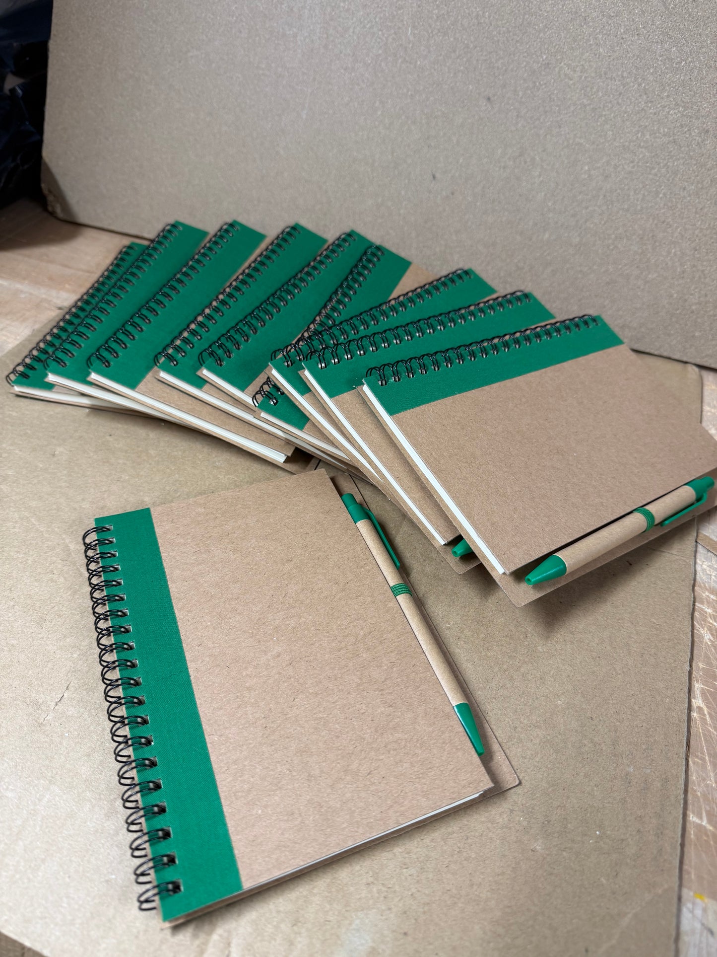 10x coloured spiral notebooks with pens