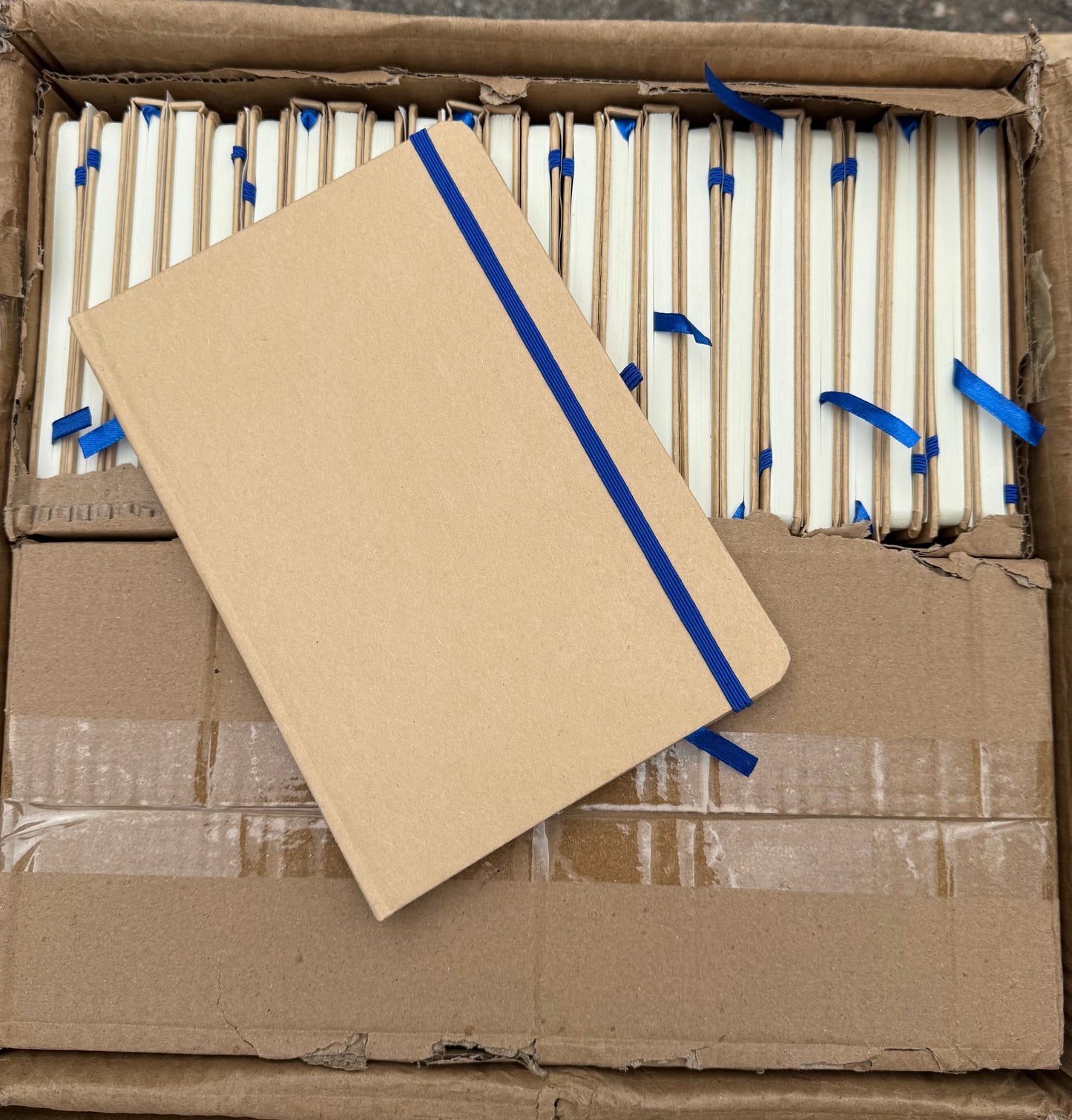 Box of 50 A5 hardback notebooks with coloured closure