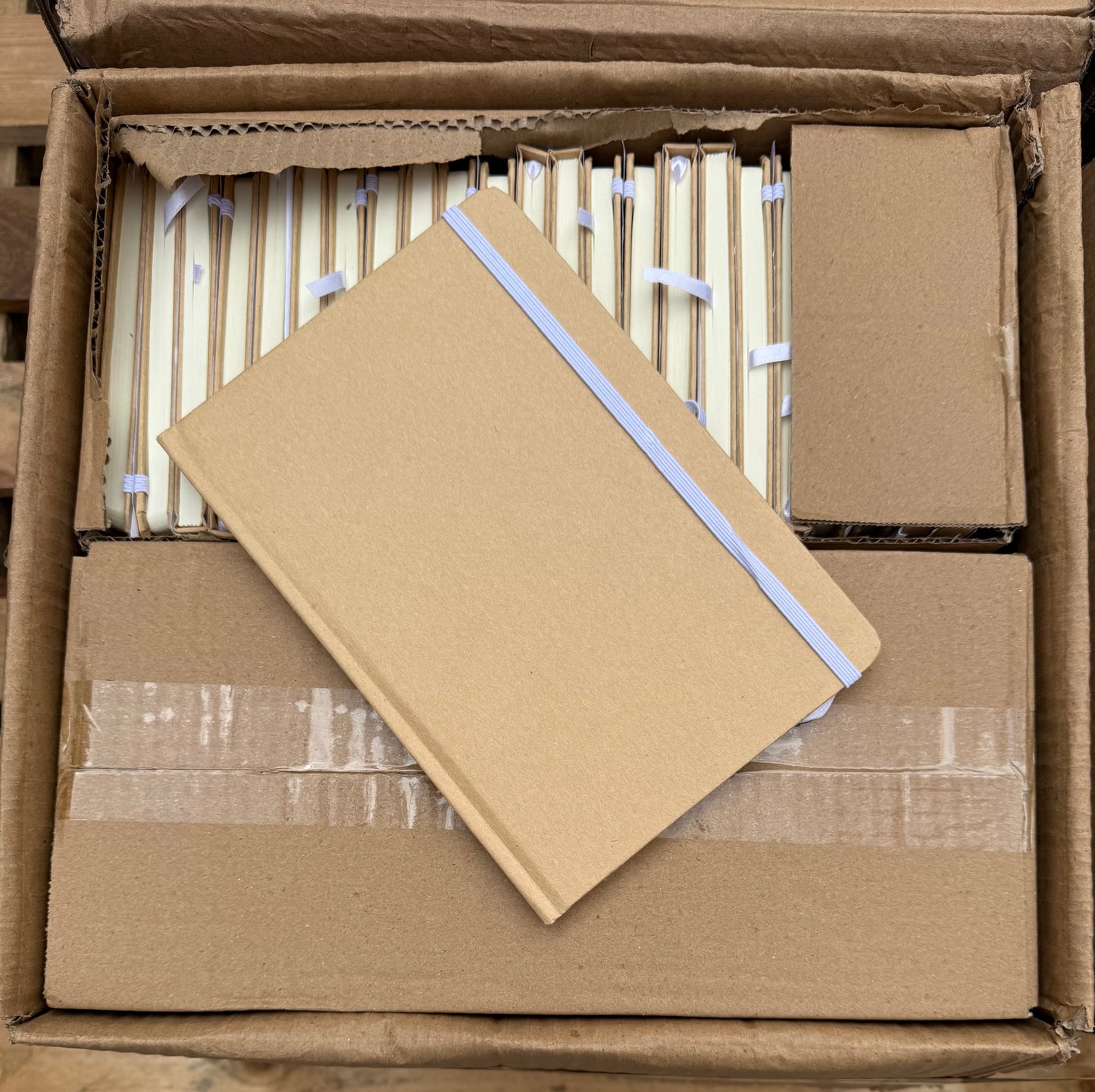 Box of 50 A5 hardback notebooks with coloured closure