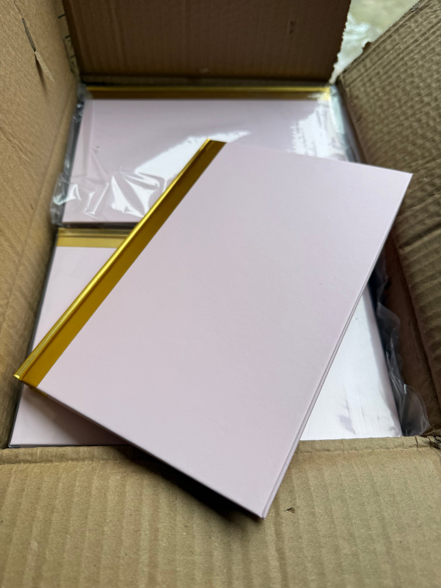 Box of 40 A5 pink hardback notebooks with gold trim