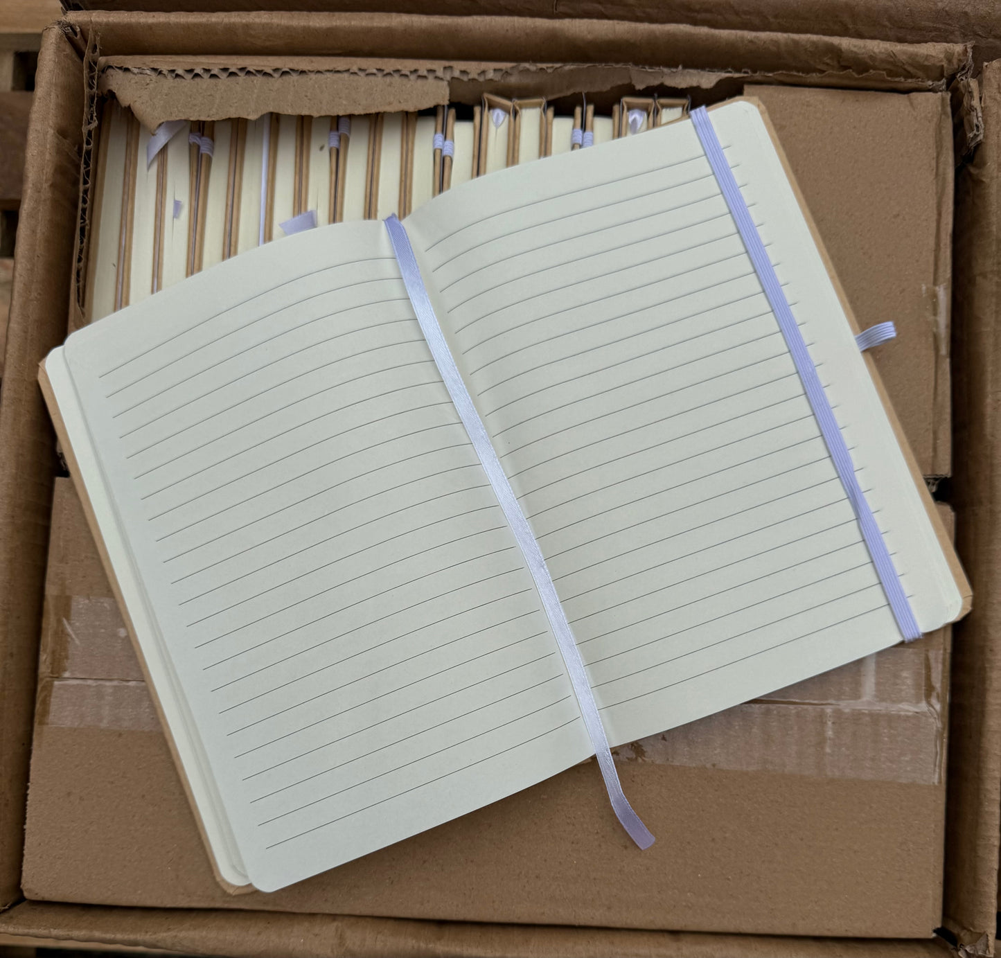 Box of 50 A5 hardback notebooks with coloured closure