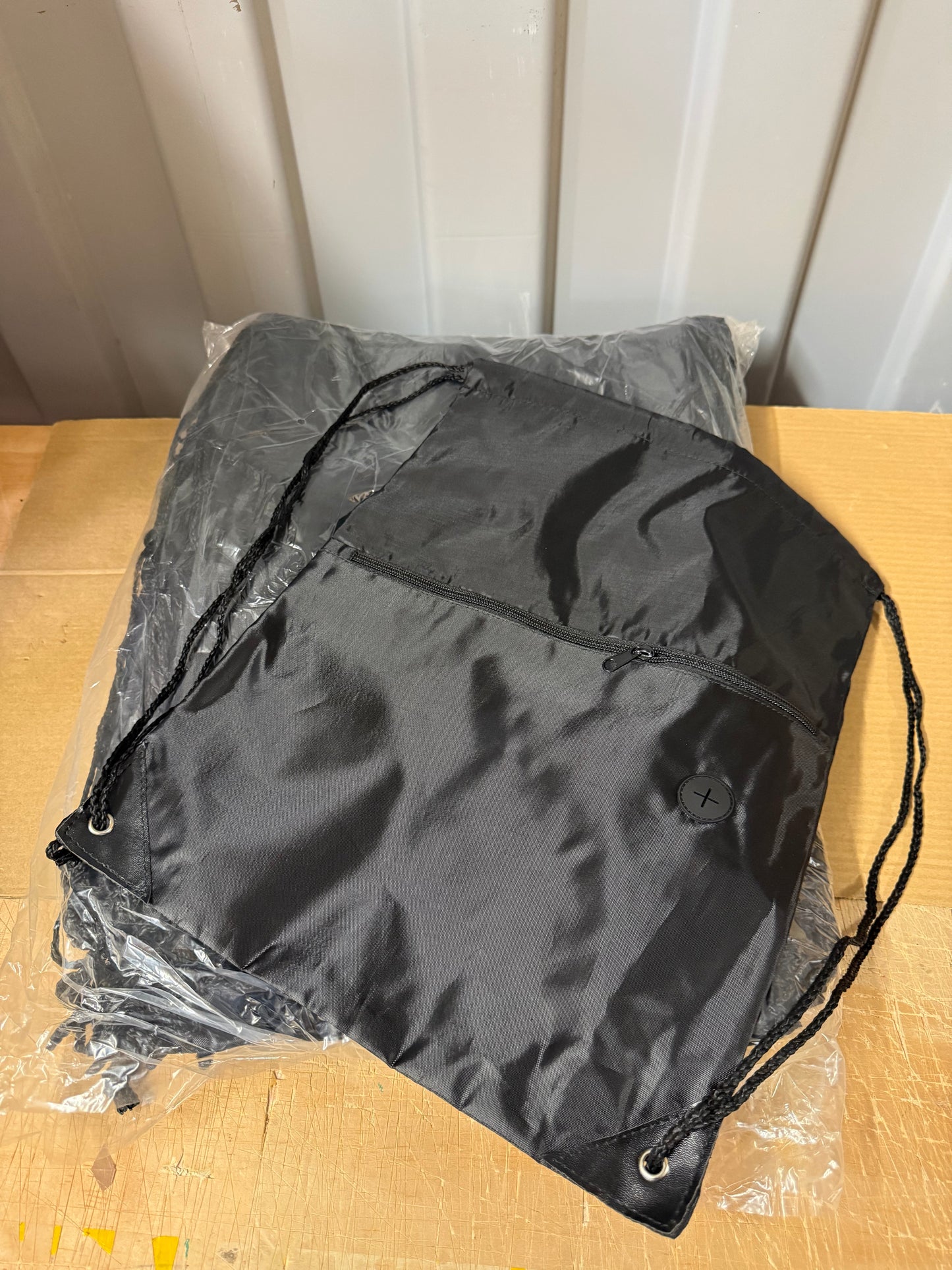 Pack of 50 Black drawstring sports bags with zip compartments