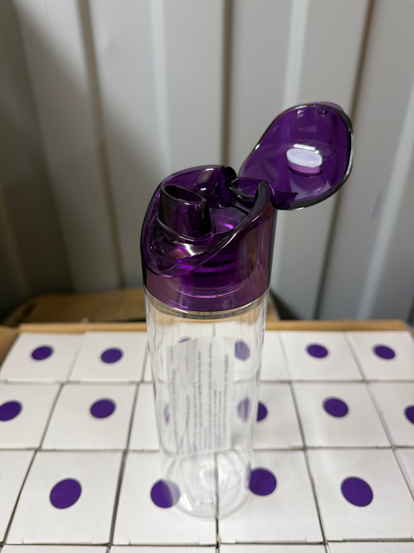 Box of 36 clear 700ml water bottles with purple flip lids