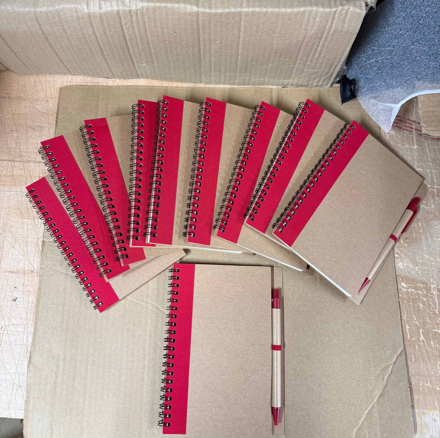 10x coloured spiral notebooks with pens
